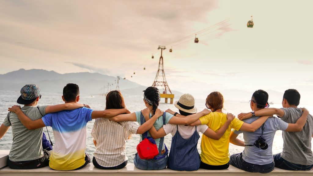 People joining hands in peer support for addiction recovery